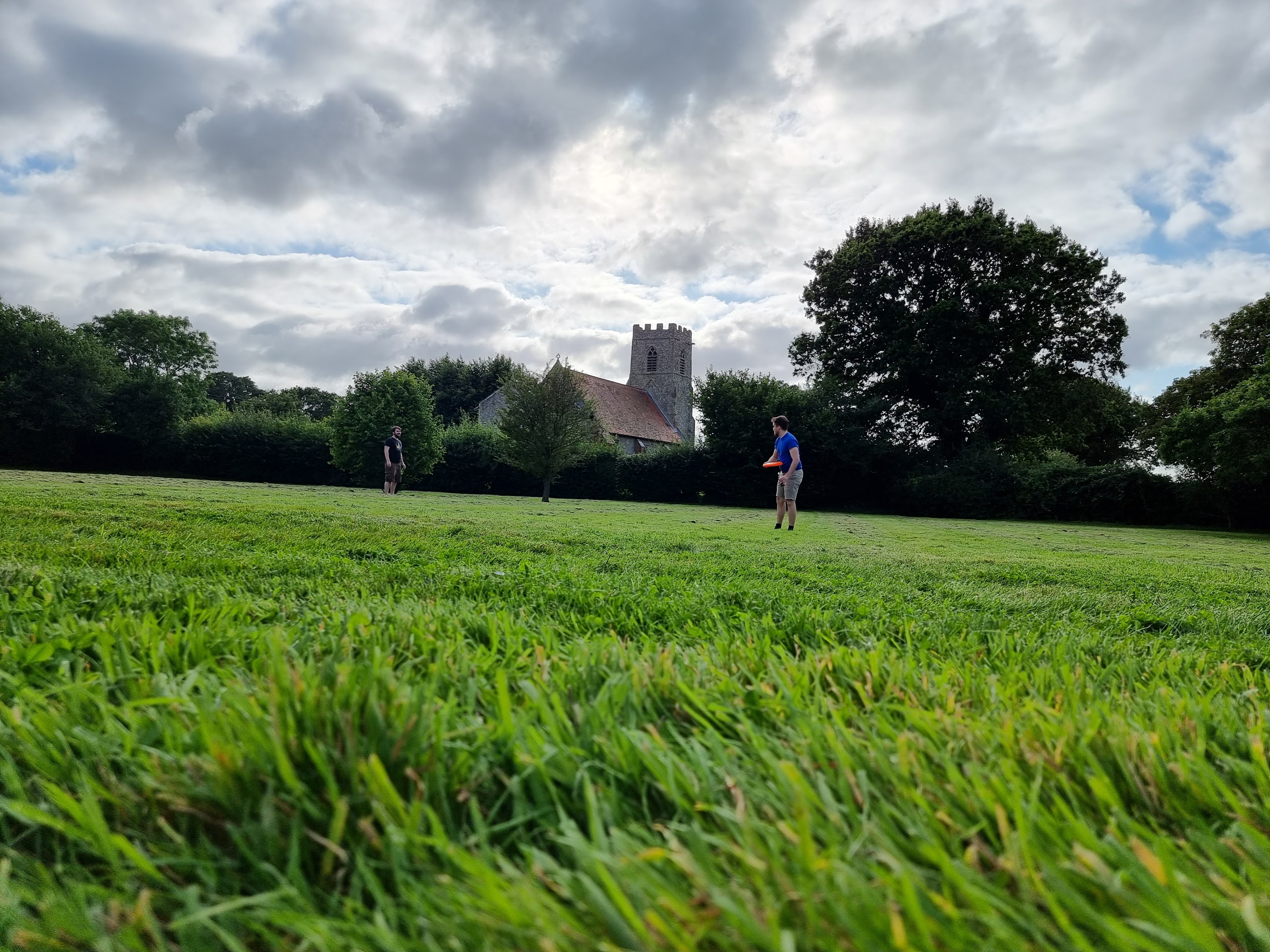 A photo of far away photo of my friends Ashley & Will throwing a frisbee around the garden A photo of far away photo of my friends Ashley & Will throwing a frisbee around the garden